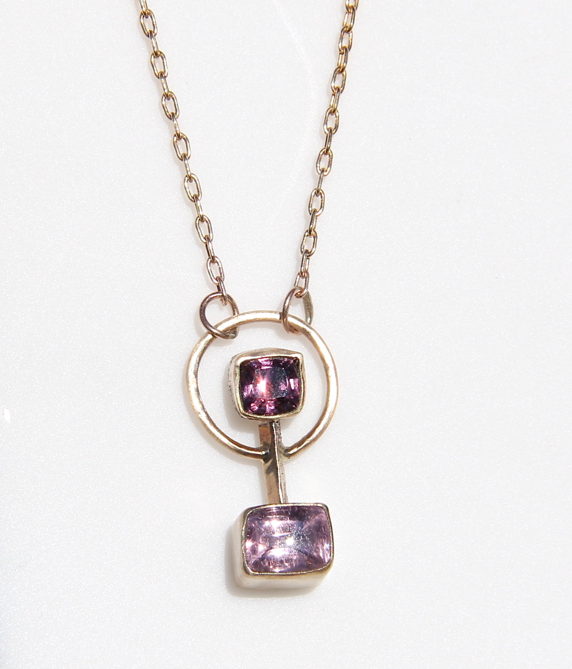 Barbell style necklace with a burgundy spinel and pink tourmaline